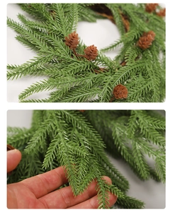 Detail of soft green PE pine needles and small pine cones on a Christmas wreath