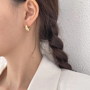 Golden croissant dome hoop earrings in 925 sterling silver worn by a fashion model