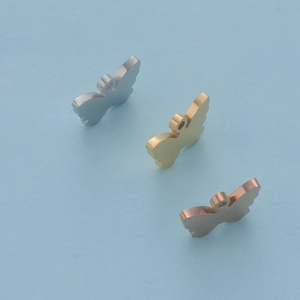 Detailed view of butterfly charms in silver, gold and rose gold stainless steel finishes