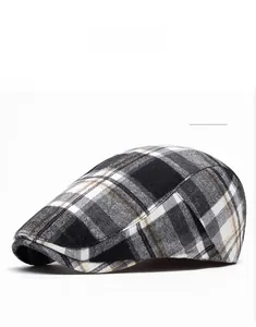 Close-up of the vintage British black and white checkered plaid pattern flat cap