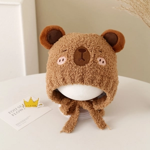 Close-up of warm brown teddy fleece baby hat with 3D bear ears and soft chin straps