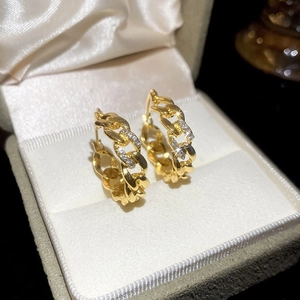 French vintage gold chain hoop earrings with sparkling diamonds in a luxury jewelry box