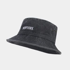 Detail shot of New York embroidery and metal air eyelets on washed grey bucket hat
