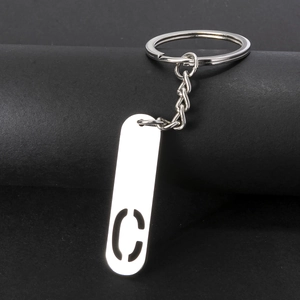 Close-up of polished silver stainless steel keychain featuring a hollow letter C pendant