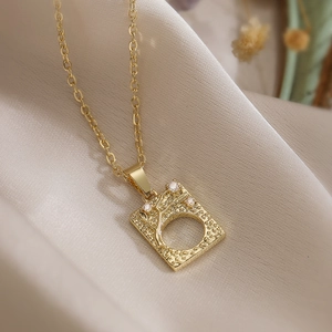 Minimalist gold plated tree of life pendant necklace with cubic zirconia on silk