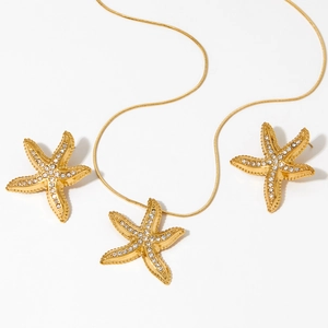 Golden 316 stainless steel starfish jewelry set with sparkling rhinestones on white