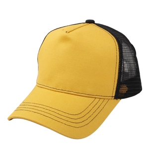 Detail shot of a yellow and black trucker hat with breathable mesh and premium stitching