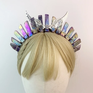 Detailed view of purple aura quartz crystals and silver angel wings on a bridal headband