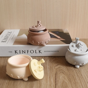 Three-piece skull lid storage jars with flame relief and tripod base in home setting