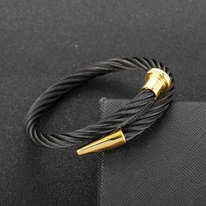 Minimalist black twisted cable bracelet with polished gold-tone caps in stainless steel