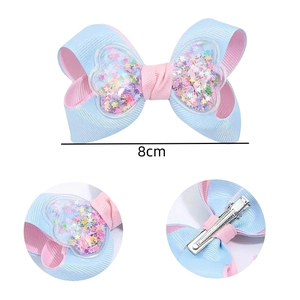 Pink and blue ribbon hair bow with glitter star sequins and durable metal clip for girls