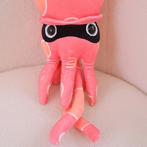 Close-up of pink Splatoon-style squid plush toy with soft gradient texture and dots