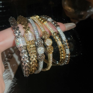 Macro shot of 18K gold and silver plated bangles set with glittering cubic zirconia stones