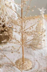 Macro shot of luxury golden Christmas crystal tree with shimmering champagne beads