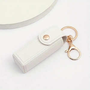 Detail of white lychee grain PU leather lipstick holder keychain with rose gold hardware