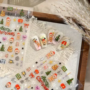 Macro detail of Christmas nail stickers featuring cute bears and holiday trees