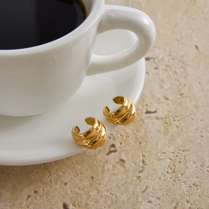 Classic 18K gold-plated stainless steel layered ear cuffs displayed on a coffee cup rim