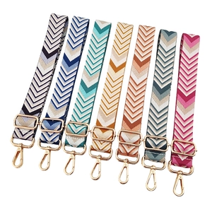 Adjustable woven guitar style bag straps with colorful geometric V-patterns and gold hardware