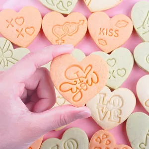 Heart-shaped 3D cookie mold set with I Love You and KISS patterns for Valentine baking