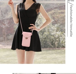 Pink faux leather mini crossbody phone bag with snap closure shown on a model