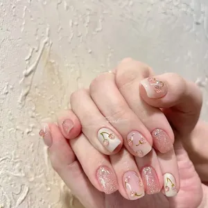 Detail of pink glitter press-on nails featuring 3D red cherry patterns and sparkling crystals