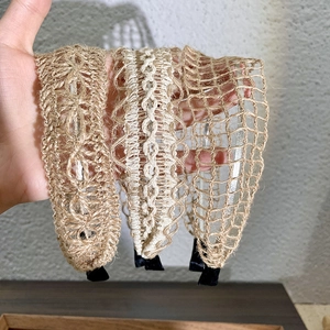 Close-up of three woven headbands in beige and light brown showing detailed mesh textures
