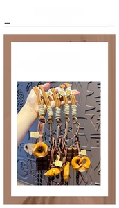 Detailed shot of creative pretzel and chocolate charms on woven rope keychain