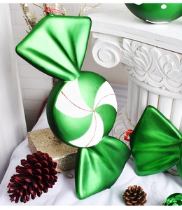 Detail of 40cm green painted Christmas candy ornament on a festive prop background