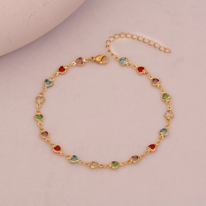 Detail of gold chain anklet with colorful heart-shaped rhinestones and lobster clasp closure