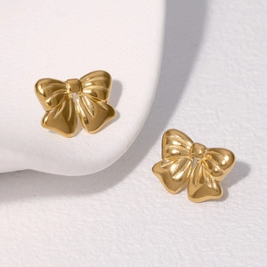 Minimalist gold bow earrings in polished stainless steel with a high-gloss 3D relief design
