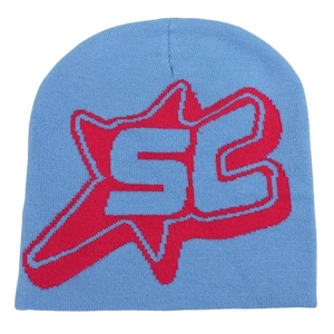 Detail of blue knitted beanie featuring red and white jacquard star and SC letter pattern