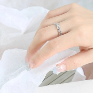 Macro detail view of a silver Chinese ancient coin ring worn on a hand for prosperity luck