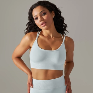 Detail view of the breathable light blue seamless knit fabric and ribbed hem of the sports bra