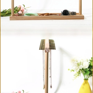 Detailed view of natural solid wood jewelry display stand for necklaces and bracelets