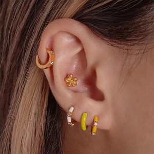 Close-up of S925 silver enamel earrings with crystals on ear in a French style