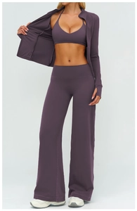 Detailed close-up of dark plum yoga set featuring long sleeve jacket and wide leg pants
