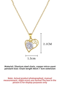 Detailed view of gold titanium steel heart pendant with sparkling white zircon inlay