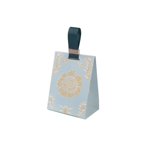 Light blue paper gift bag with gold floral patterns and dark green handle for weddings