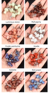 Macro shot of assorted natural stone mushroom pendants with silver rings for jewelry DIY