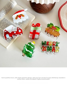 Close-up of festive Christmas hair claw clips with glittery Santa and tree designs