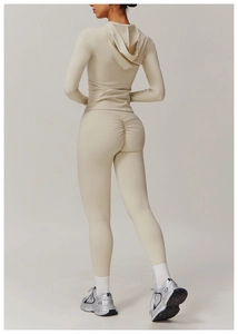 Detailed back view of a slim-fit beige yoga set featuring a hooded top and lift leggings