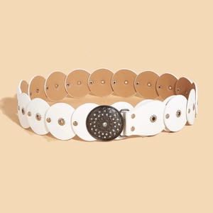 White leather Western belt with mandala buckle and rivets, coiled on a beige backdrop