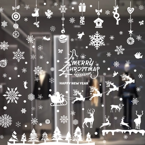 White Christmas window decals with Santa, reindeer and snowflakes on glass background