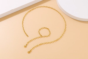 Detail shot of golden hammered textured oval link chain necklace with lobster clasp