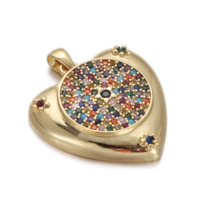 Macro detail of 14K gold plated heart pendant with colorful gems and black star