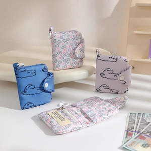 Detailed view of floral canvas coin purses with snap buttons and internal zipper pockets