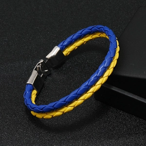 Close-up of blue and yellow braided leather bracelet with a polished metal magnetic clasp