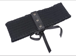 Close-up of black elastic lace waist belt with snap buttons and ribbon lace-up detail