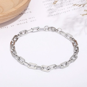 Detail of silver geometric rhombus chain bracelet on minimalist Nordic background