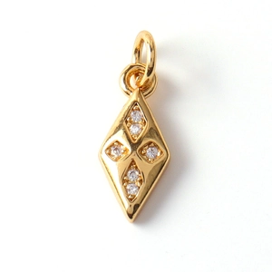 Macro detail of gold-plated rhombus charm featuring four inlaid cubic zirconia stones